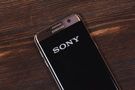 Kazan, Russian Federation - Aug 5, 2018: Man holding smartphone with Sony logo with the finger on the screenのeditorial素材