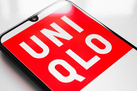 RUSSIA, KAZAN MAY 1, 2019: Clothing store UNIQLO logo on a white background on the smartphone screen