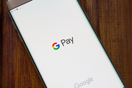 Kazan, Russian Federation - Sep 15, 2017: hand holding a brand new Samsung Galaxy S7 mobile phone which displays the Android Pay app on the touch screenのeditorial素材