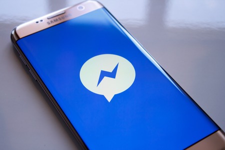 Kazan, Russian Federation - Jun 15, 2018: Facebook Messenger application on screen of modern smartphone close-up. Install menu of Messenger app in Play Store. Apps icon of Messenger.のeditorial素材