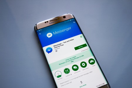 Kazan, Russian Federation - Jun 15, 2018: Facebook Messenger application on screen of modern smartphone close-up. Install menu of Messenger app in Play Store. Apps icon of Messenger.のeditorial素材