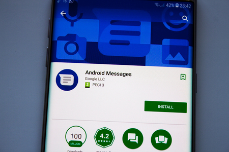 Kazan, Russian Federation - Jun 15, 2018: smart phone display android messenger app with earphones on wood backgroundのeditorial素材