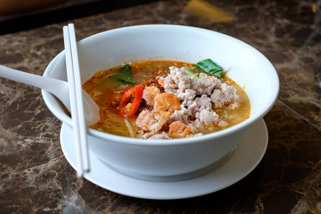 Close up of Thai Spicy noodle soup in a bowl (Tom Yam)の写真素材