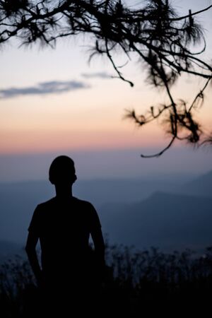 Silhouette of man on the mountain with sunrise. Element of design.の写真素材