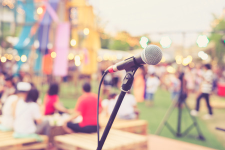 Close up of microphone in concert or conference room with blur people in the backgroundの写真素材