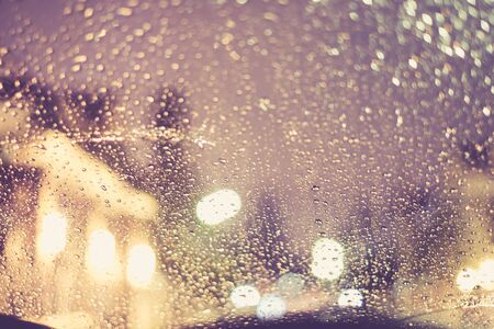 Vintage tone of :Drops Of Rain on the window with house in the back for Backgroundの写真素材