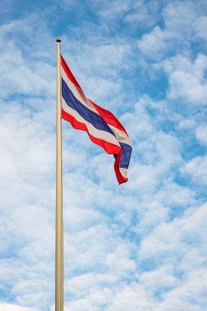 flag of Thailand with blue sky background.