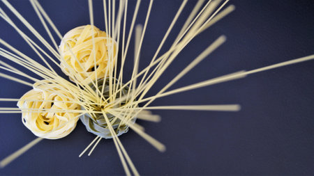 Pasta in the shape of a flower on a blue background.の写真素材