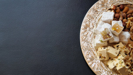 Turkish delight with nuts on a black background. Top view, copy spaceの写真素材