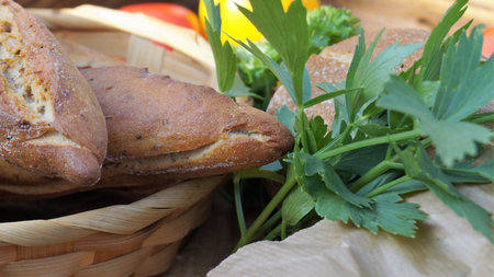 Fresh bread and vegetables on the wooden background. Selective focus.の写真素材