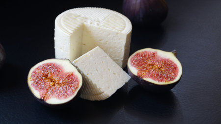 cheese camembert with fresh figs on a black backgroundの写真素材
