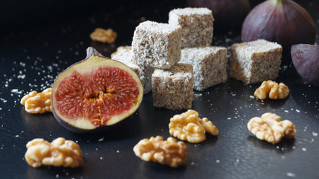 Figs, walnuts and sugar cubes on a black background.の写真素材
