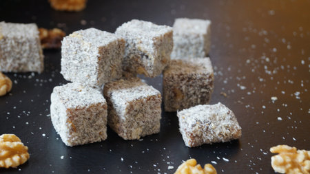 Turkish delight with walnuts on a black background. Selective focus.の写真素材