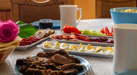 Breakfast table with a variety of food on a wooden table.の写真素材