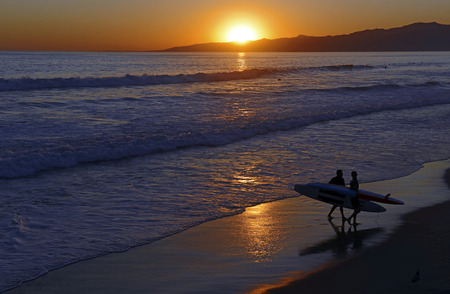 Sunset and Surf over the ocean on the beach の写真素材