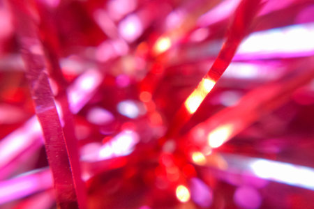 Crimson blurred tinsel, Christmas decorations closeup, abstract background or textureの写真素材