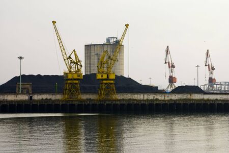 Two yellow cranes in the portの写真素材