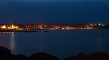 Skyline at night with the sea and the coastlineの写真素材