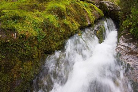 Water fall among stones in spring