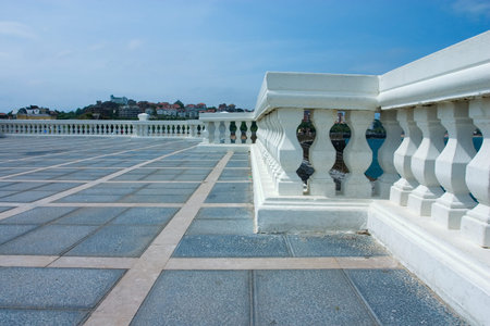 white balustrade with a city in the background