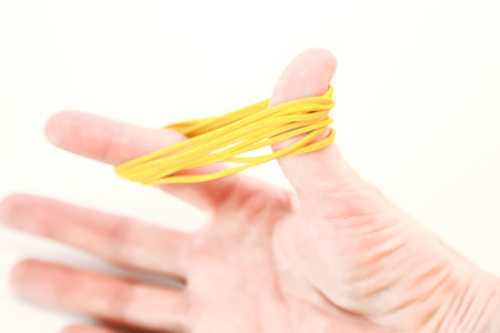 Rubber bands for office isolated on white background and handheldの写真素材
