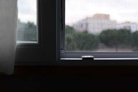 Mosquito net on a PVC windowの写真素材