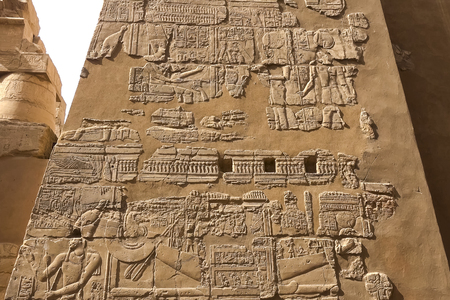 Egyptian hieroglyphs and drawings on the walls and columns. Egyptian language, The life of ancient gods and people in hieroglyphics and drawingsのeditorial素材
