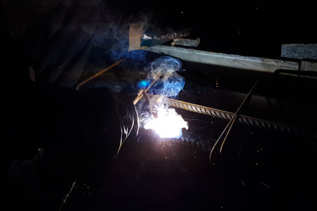 Welding of steel reinforcement. Sparks and light from welding. Electric welding.