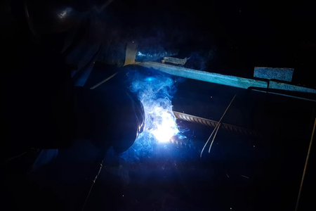 Welding of steel reinforcement. Sparks and light from welding. Electric welding.