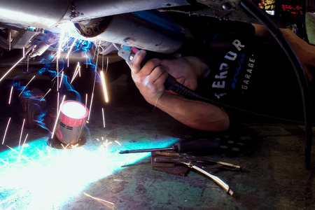 Moscow, Russia - May 14, 2018: Welding works during the car repair. Exhaust system repairのeditorial素材