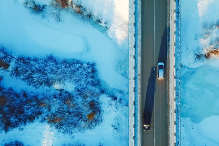 Car rides on a bridge over a ravine, view from above.
