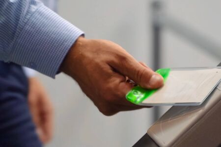 The pass attaches his hand to the turnstile. The bandwidth system.の写真素材