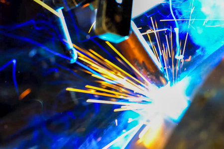 Pipe welding. Welding works. Sparks of welding