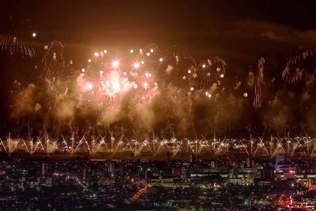 Festive salute in the night sky. Salute over the city the megalopolis. Explosions of fireworks.の写真素材