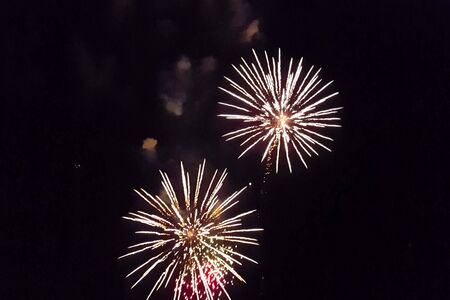 Festive salute in the night sky. Explosions of fireworks.の写真素材