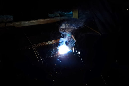 Welding of steel reinforcement. Sparks and light from welding. Electric welding.