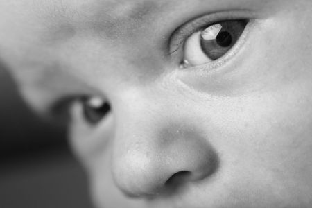 Closeup of a baby face: sweet and shinning eyes. The baby is 3 months old.の写真素材