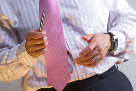 Businessman is counting on hands while he is explaning his calculations.の写真素材