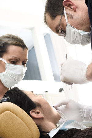 Young female patient takes a dental attendance in the dentist's office.