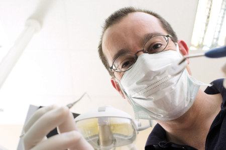 Young female patient takes a dental attendance in the dentist's office.