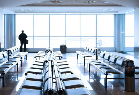Transit lounge at the airport with human silhouette.の写真素材