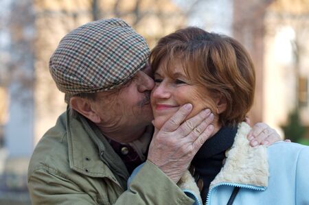 Happy senior couple kiss each other.の写真素材