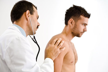 Doctor examining young male patient. 