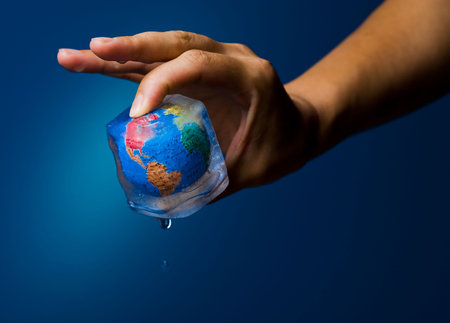 Conceptual image about saving Earth. The globe  frozen into an icecube thrawing.