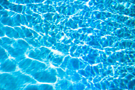 Blue water texture in pool at summer.