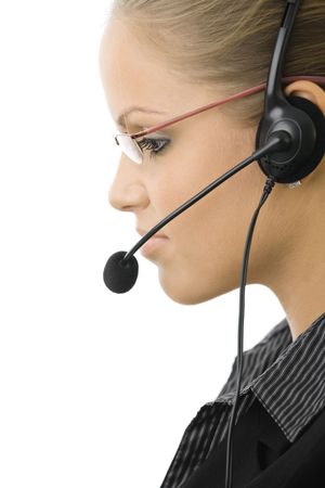 Young customer service operator girl wearing headset, side view, isolated on white background.の写真素材
