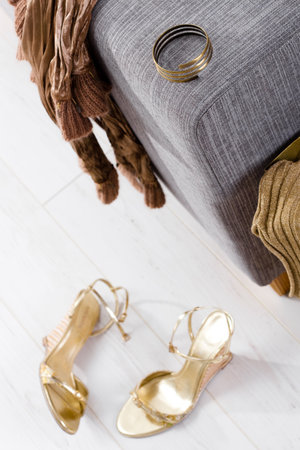 Newly bought femal clothes, shoes and bracelet packed out at home. Selective focus placed on the...