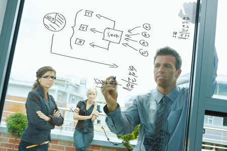 Business team planning, businessman thinking drawing diagram on window. Outdoor of office on...
