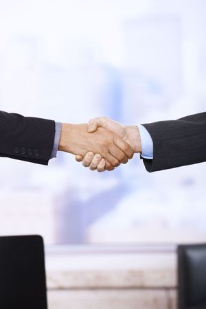 Handshake in closeup in business situation in office.の写真素材