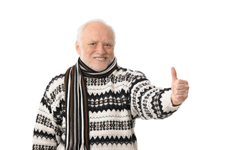 Portrait of happy senior man looking at camera, showing thumb up, laughing, isolated on white.の写真素材